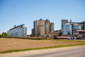 Obraz premium silos granary elevator on agro-industrial complex with seed cleaning and drying line for grain storage