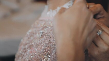 A skilled dressmaker fitting a dress on a mannequin, exhibiting utmost care and detail.