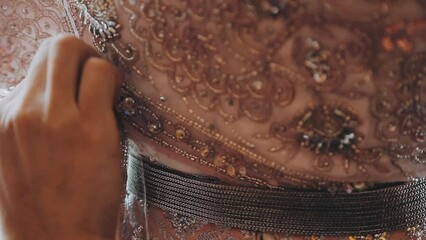 A skilled dressmaker fitting a dress on a mannequin, exhibiting utmost care and detail.