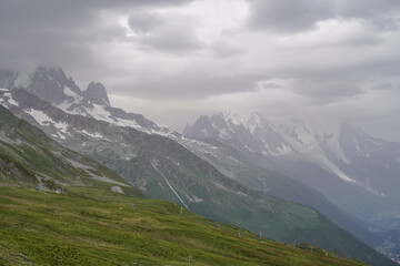 Obraz premium Beautiful views over the mountains with snow on the top of the mountains. The nature while hiking the Tour du Mont Blanc. 
