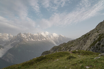 Fototapeta premium Beautiful views over the mountains with snow on the top of the mountains. The nature while hiking the Tour du Mont Blanc. 