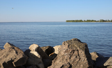 panorama on the lake. rocky shore and horizon view on the water