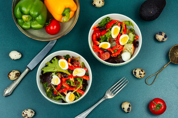 Vegetable salad with quail eggs.