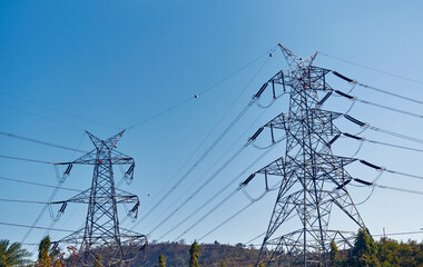 rows of electricity transmission towers across hilly region in Baghmundi, Purulia, West Bengal....