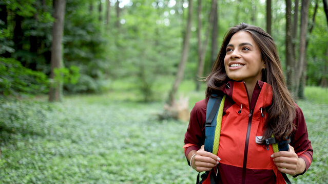 Beautiful, young woman hiking and enjoying in the nature