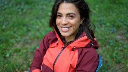 Beautiful, young woman  taking a break during hiking and enjoying in the nature