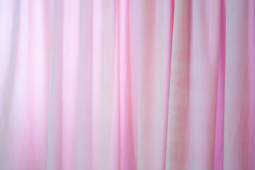 A pink curtain with white stripes