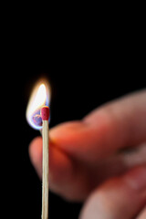 Moment of lighting a match on a dark background. Macro. Background. Texture. Close-up