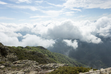 The sky is cloudy and the mountains are covered in trees