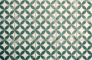 Vintage green and white geometric tiled floor with a worn effect
