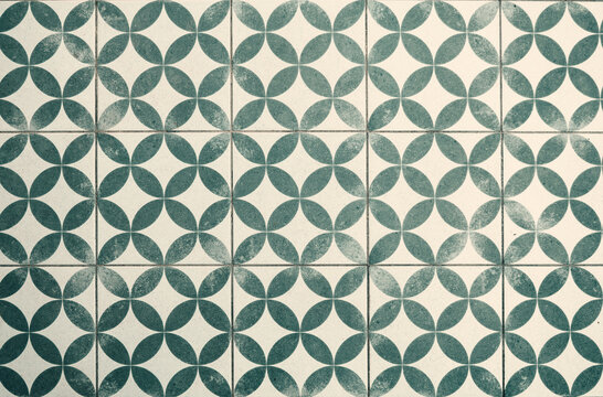 Vintage green and white geometric tiled floor with a worn effect