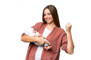 Young blonde woman  with her newborn baby over isolated chroma key background celebrating a victory