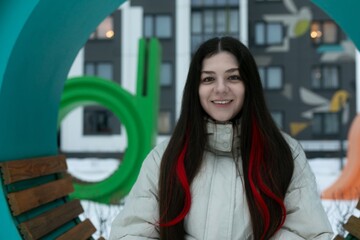 Woman With Long Hair Standing in Front of a Bench