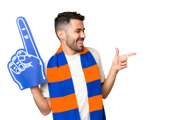 Young caucasian sports fan man over isolated chroma key background pointing finger to the side and...