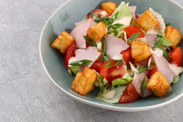 Salad with spinach, cheese, ham, grapefruit and balsamic sauce on a wooden rural background. Top view. Close-up.