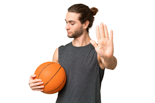 Young basketball player man over isolated background making stop gesture and disappointed