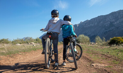 Fototapeta premium children with helmet enjoy having fun riding bike in nature
