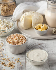 Cottage cheese, sour cream and butter on white rustic table