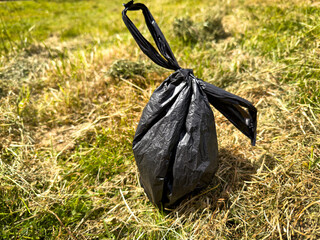 Dog poo bag on the grass