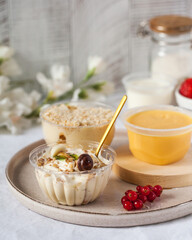 Dairy dessert with honey and berries on tray in kitchen