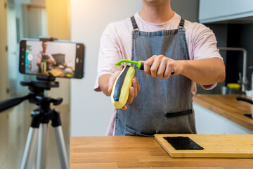 The chef is broadcasting live from workshop how to prepare a grilled eggplants with garlic