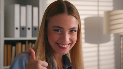 Happy excited carefree Caucasian woman dancing cheerful moving showing thumbs up super thumb...