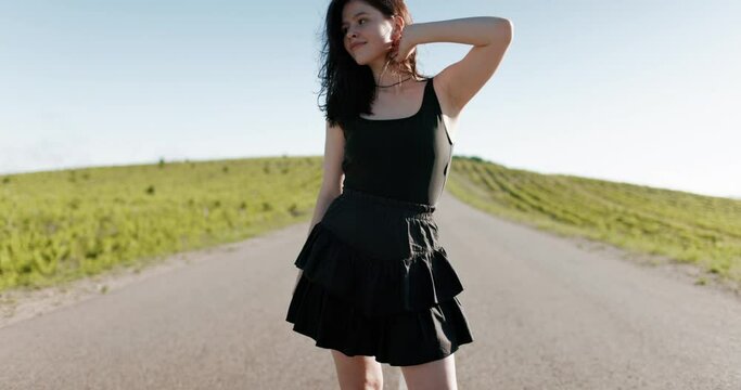 Attractive caucasian woman on roller skates posing outdoor in sunny day.