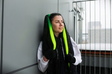 Woman With Green Hair Leaning Against Wall