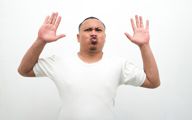 Naklejka premium Surrender gesture of Asian man raising his hands