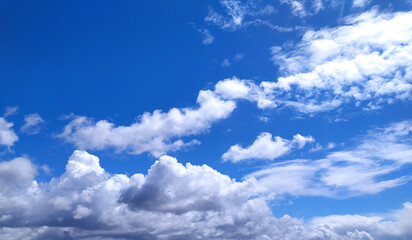 Clear blue sky texture and white fluffy cloud nature background. The sun shines bright in the daytime in summer