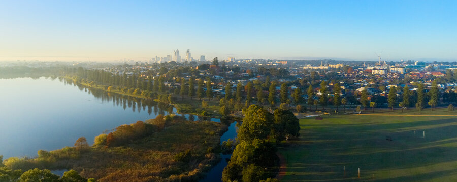 Aerial panoramic view of Lake Monger and adjacent park with the Perth City skyline on the horizon