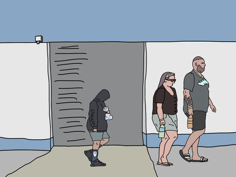 Family of three walking past warehouse in country town