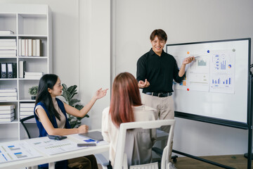 Business Meeting in Modern Office with Diverse Team Discussing Financial Charts and Graphs on Whiteboard
