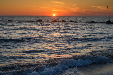 Naklejka premium beautiful golden sunset on the Mediterranean coast on the island of Cyprus 1