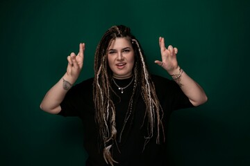 Woman With Dreadlocks in Front of Green Background