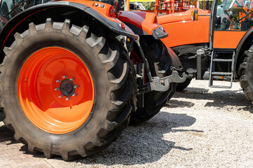 Row of red agricultural tractors for sale.