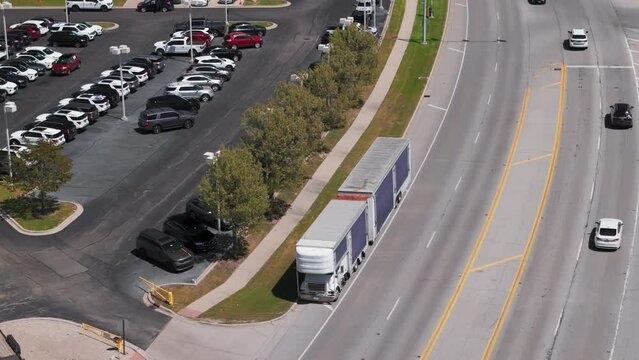 Aerial view of a Enclosed Luxury Car Hauler stand of a dealership 