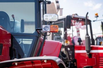 Row of red agricultural tractors for sale.