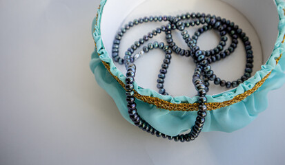 Top view of black pearl beads in a handmade jewelry box