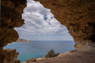 Gozo Island Malta,  View of Ramla Bay, from inside Tal Mixta Cave Gozo looking out over the blue ocean on a bright day.