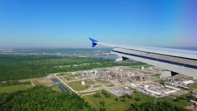 Louis Armstrong New Orleans International Airport MSY wide view from the porthole of the landing airplane. Wide shot