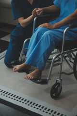 Obraz premium Doctor giving hope. Close up shot of young female physician leaning forward to smiling elderly lady patient holding her hand in palms. Woman caretaker in white coat supporting encouraging old person