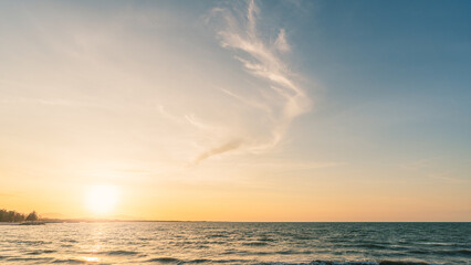 Sunset Sky clouds with orange, yellow golden hour over horizon sea in the evening in summer season backgrounds 