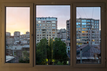 view through glass balcony on evening city