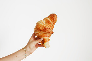 Hand Holding Freshly Baked Croissant. Delicious French Pastry. Croissant. 