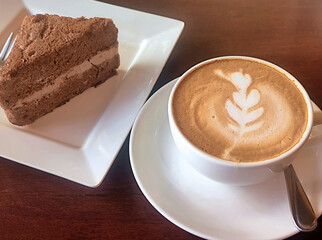 Hot latte and chiffon cake on wooden table
