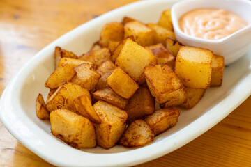 patatas bravas (spicy potatoes) A ​​traditional snack in Spain consisting of baked or boiled potatoes dipped in sauce, Spanish Cuisine
