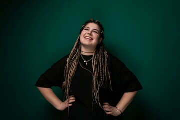 Woman With Dreadlocks Standing in Front of Green Background