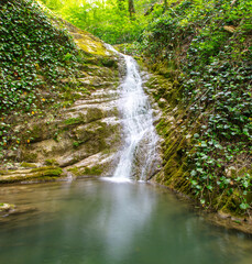 Waterfall on the river in nature in summer