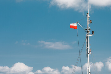 Polish flag with emblem on the ship's mast 
